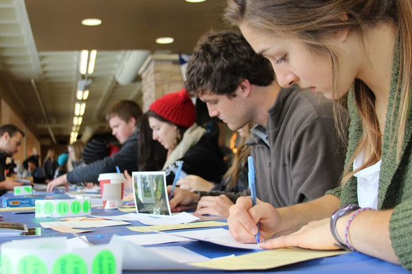 Students writing thank you cards at donor recognition event.